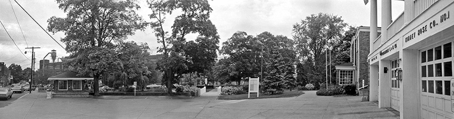 Panoramic view of Butler NJ bus station, park and firehouse, 1975.