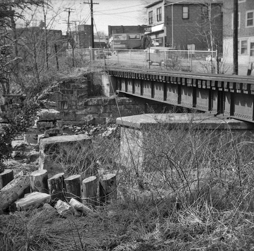 Black and white photo of railroad bridge along Main St., Butler NJ